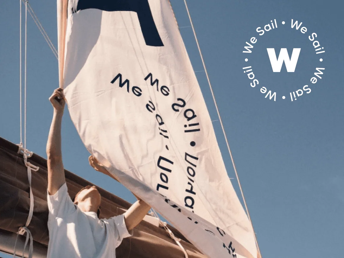 We Sail: a sail printed with the round badge